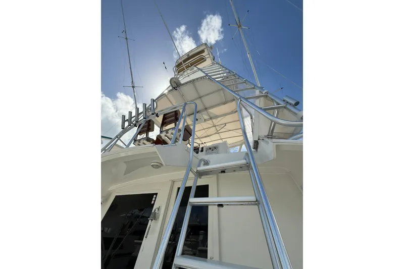 Slide: The Image of 1988 Bertram 43 Flybridge yacht ladder under clear blue sky. - 57