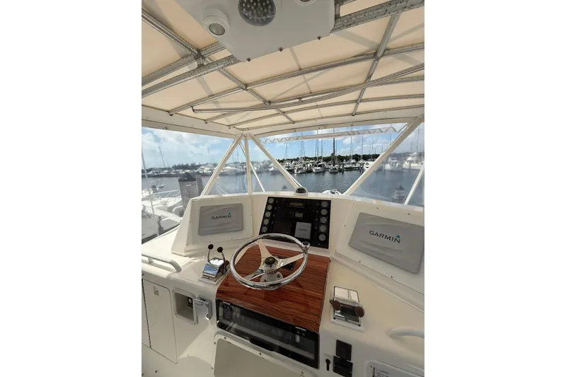 Slide: The Image of 1988 Bertram 43 Flybridge helm with Garmin navigation, overlooking marina. - 61