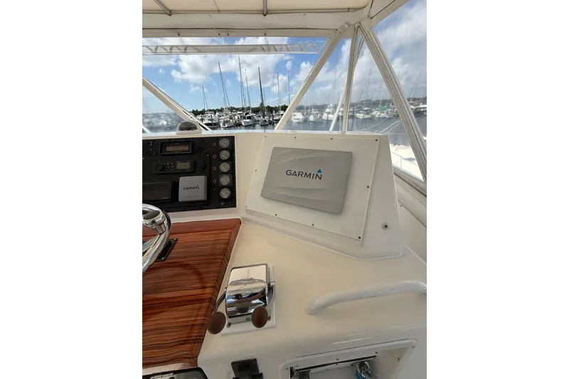Slide: The Image of 1988 Bertram 43 Flybridge helm with Garmin navigation system, overlooking marina. - 62