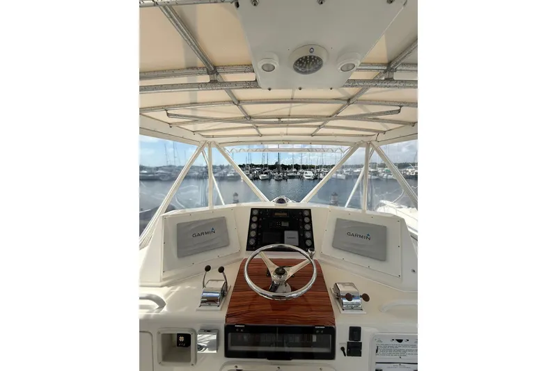 Slide: The Image of 1988 Bertram 43 Flybridge helm with Garmin navigation, overlooking marina. - 66