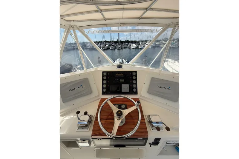 Slide: The Image of 1988 Bertram 43 Flybridge helm with Garmin navigation, overlooking marina. - 67