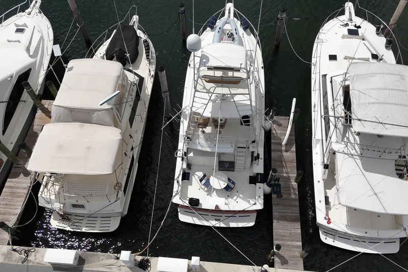 Slide: The Image of Overhead view of a 1988 Bertram 43 Flybridge yacht docked among other boats. - 7