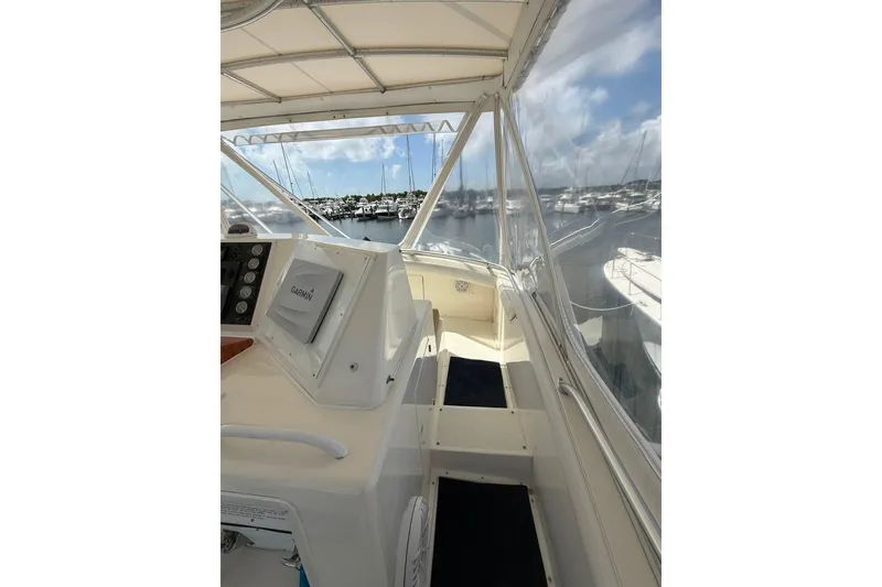 Slide: The Image of 1988 Bertram 43 Flybridge interior with Garmin navigation, overlooking marina. - 70