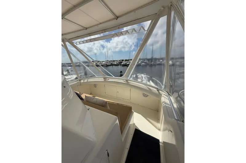 Slide: The Image of 1988 Bertram 43 Flybridge interior with marina view through clear windows. - 71