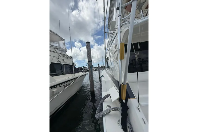 Slide: The Image of 1988 Bertram 43 Flybridge yacht docked, showcasing sleek design and sturdy build. - 84