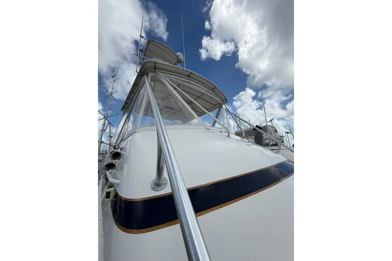 Slide: The Image of 1988 Bertram 43 Flybridge yacht with clear sky and clouds. - 85