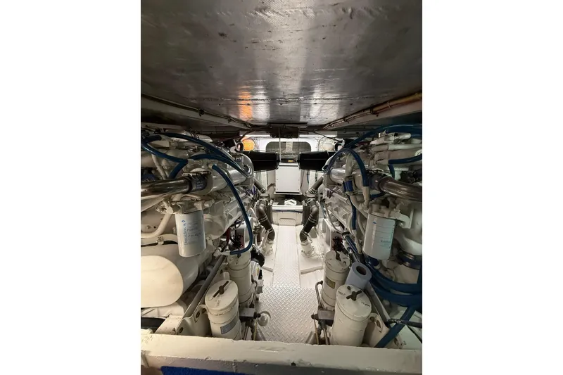 Slide: The Image of Engine room of 1988 Bertram 43 Flybridge with visible machinery and components. - 93