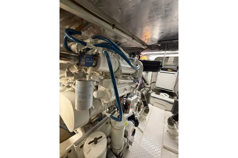 Slide: The Image of Engine room of 1988 Bertram 43 Flybridge with visible marine components. - 94
