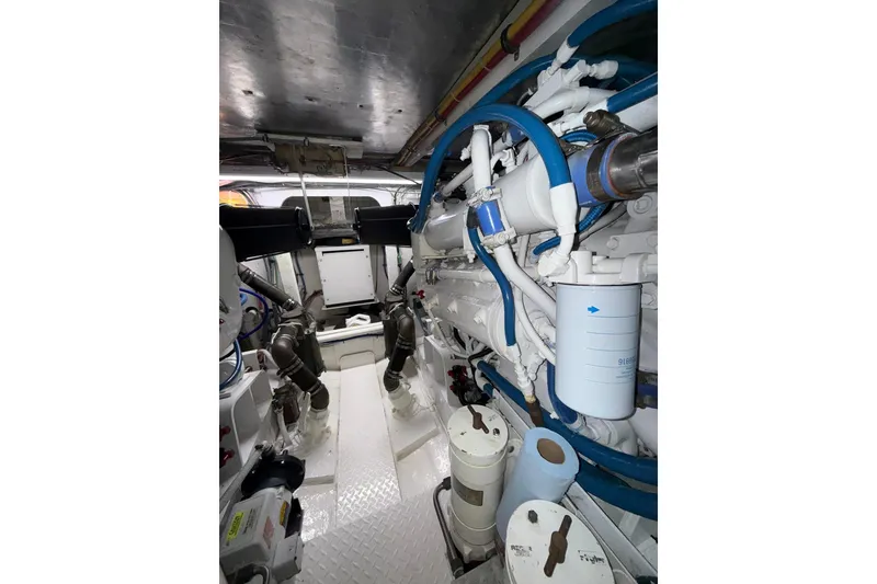 Slide: The Image of Engine room of 1988 Bertram 43 Flybridge with visible pipes and machinery. - 96