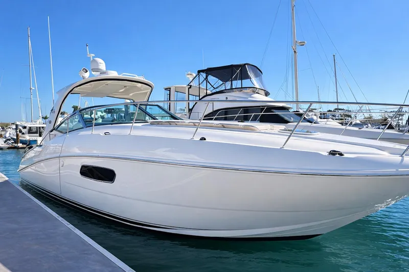 The Image of 2010 Sea Ray Sundancer 370 yacht docked in a marina under clear blue skies. - 0