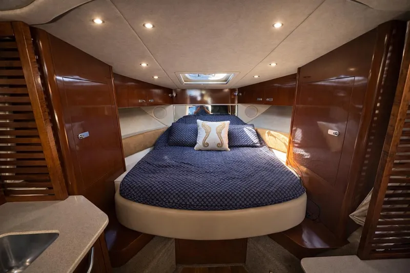 Slide: The Image of Luxurious cabin interior of 2010 Sea Ray Sundancer 370 yacht with cozy bedding. - 10