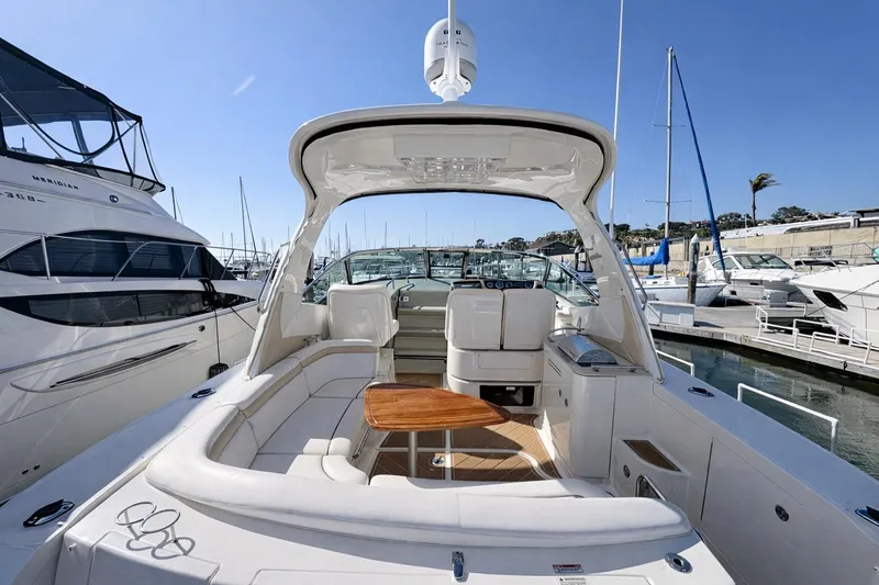 Slide: The Image of 2010 Sea Ray Sundancer 370 yacht with spacious deck and seating at marina. - 11