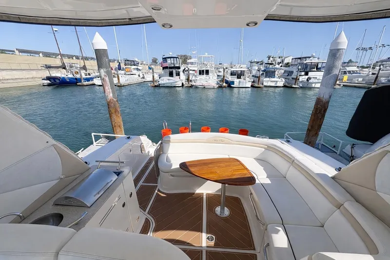 Slide: The Image of Luxurious 2010 Sea Ray Sundancer 370 yacht interior at marina, featuring elegant seating and table. - 12