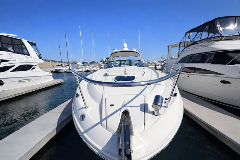 Slide: The Image of 2010 Sea Ray Sundancer 370 yacht docked at marina, surrounded by other boats. - 13