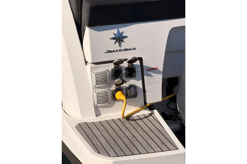 Slide: The Image of 2020 Jeanneau NC 895 boat stern with power connections and logo. - 11