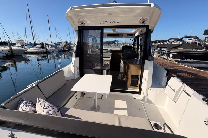 Slide: The Image of 2020 Jeanneau NC 895 boat interior with seating and table at marina. - 14