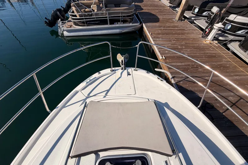 Slide: The Image of 2020 Jeanneau NC 895 boat docked, featuring bow deck and railing. - 19