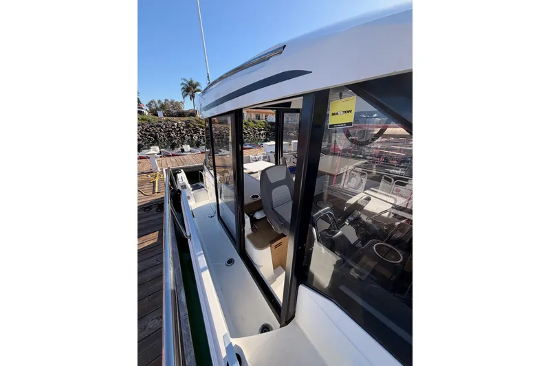 Slide: The Image of 2020 Jeanneau NC 895 boat docked, showcasing sleek design and spacious interior. - 27