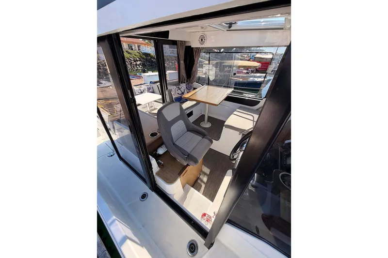 Slide: The Image of 2020 Jeanneau NC 895 boat interior with seating and table, docked at marina. - 28