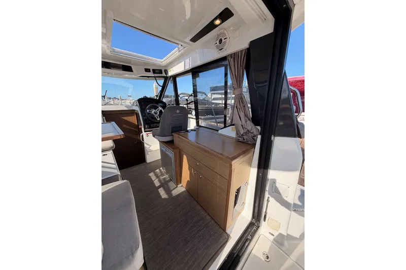 Slide: The Image of Interior of 2020 Jeanneau NC 895 boat, featuring helm and seating area. - 34
