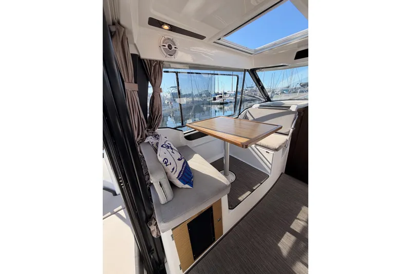 Slide: The Image of Interior of 2020 Jeanneau NC 895 boat with seating and table, marina view. - 35