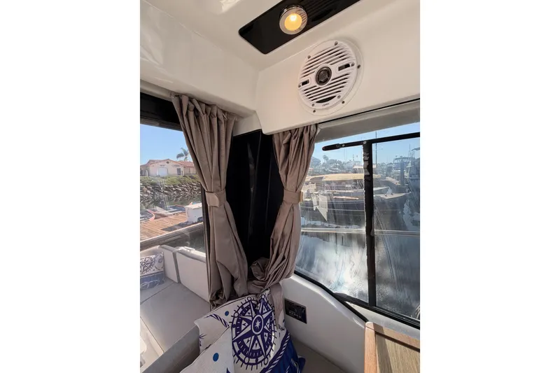 Slide: The Image of Interior of 2020 Jeanneau NC 895 boat with curtains and nautical-themed decor. - 38