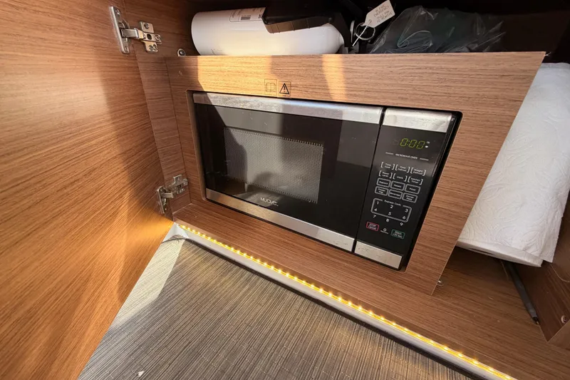 Slide: The Image of Microwave in Jeanneau NC 895 boat interior, 2020 model, with wood finish cabinetry. - 42