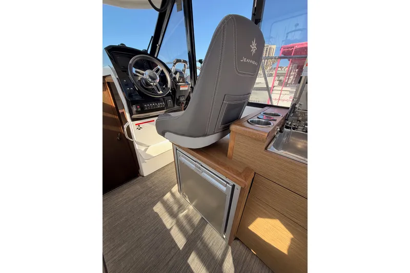 Slide: The Image of Interior of 2020 Jeanneau NC 895 boat with helm, steering wheel, and seating. - 43