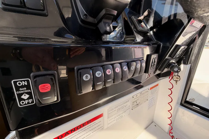 Slide: The Image of Control panel of a 2020 Jeanneau NC 895 boat with switches and key ignition. - 49