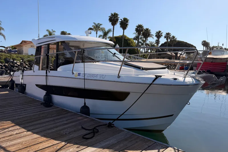 Slide: The Image of 2020 Jeanneau NC 895 boat docked at marina with palm trees in background. - 5