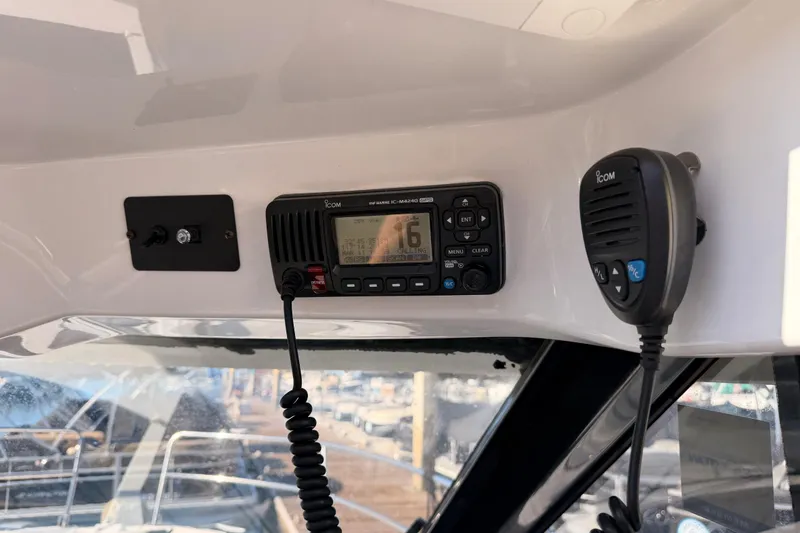 Slide: The Image of VHF marine radio on 2020 Jeanneau NC 895 boat dashboard. - 54