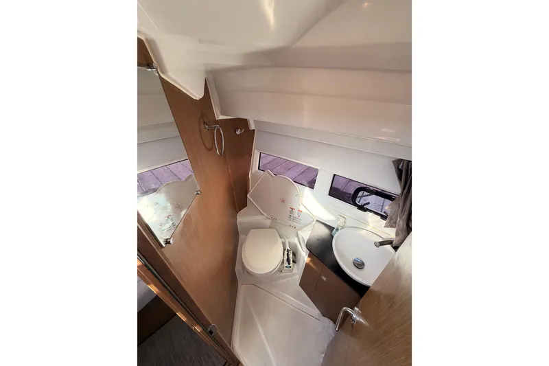 Slide: The Image of 2020 Jeanneau NC 895 boat bathroom with toilet, sink, and mirror. - 60