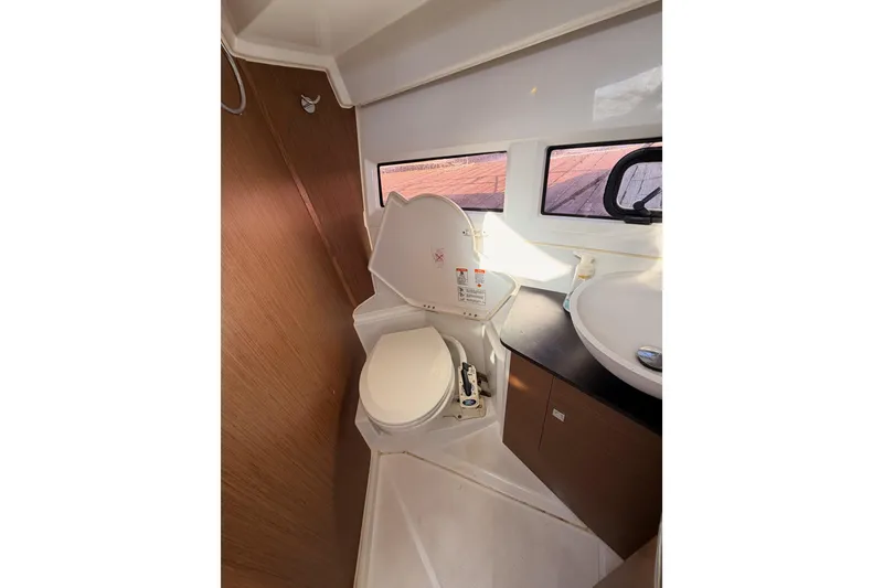 Slide: The Image of 2020 Jeanneau NC 895 boat bathroom with toilet, sink, and window. - 62