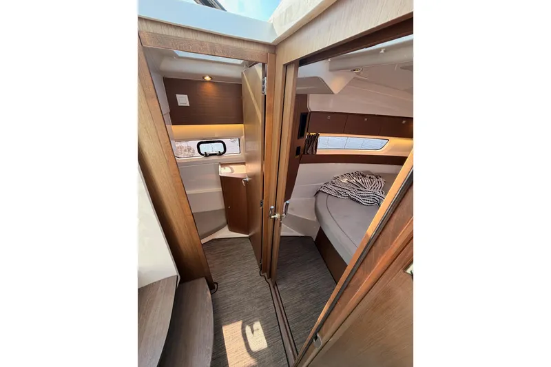 Slide: The Image of 2020 Jeanneau NC 895 interior cabin with cozy bed and modern wood finish. - 64