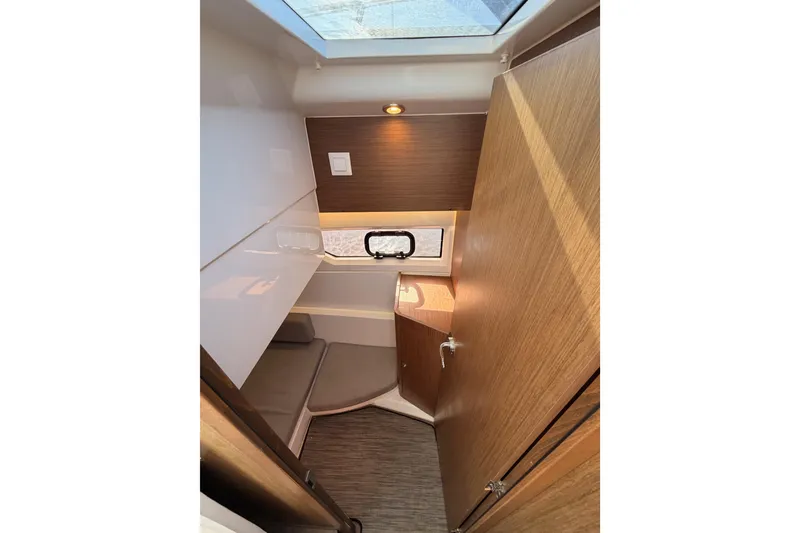 Slide: The Image of 2020 Jeanneau NC 895 cabin interior with wood finish and skylight. - 65