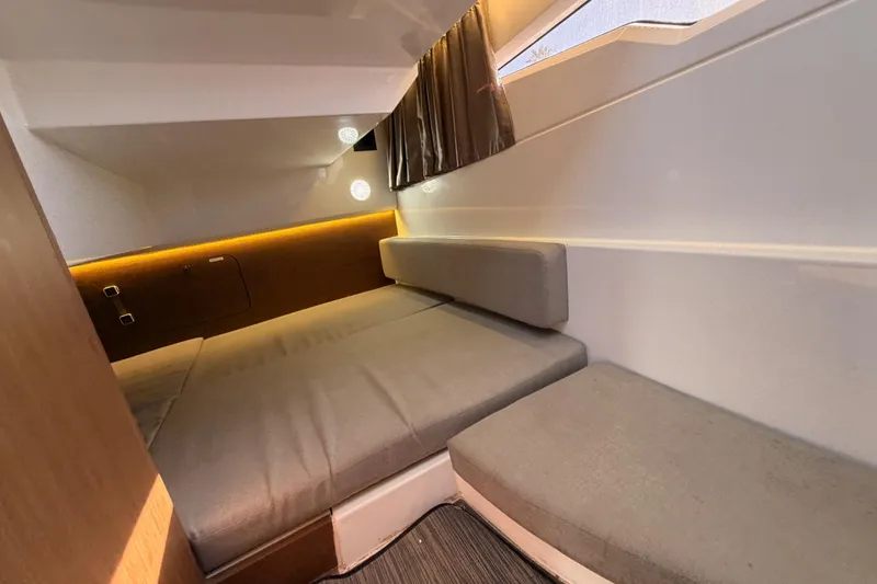 Slide: The Image of 2020 Jeanneau NC 895 cabin interior with cozy seating and ambient lighting. - 66