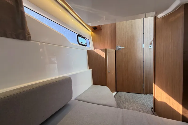 Slide: The Image of 2020 Jeanneau NC 895 cabin interior with modern wood finish and seating. - 69