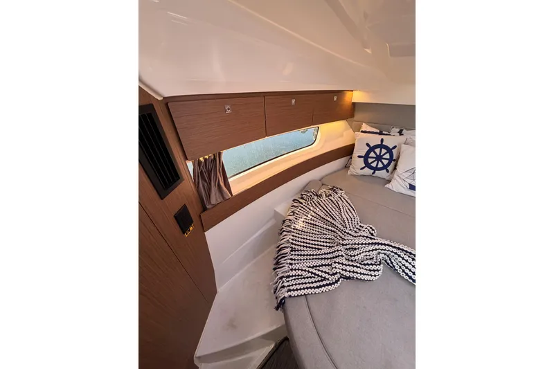 Slide: The Image of 2020 Jeanneau NC 895 cabin interior with cozy bedding and nautical decor. - 73