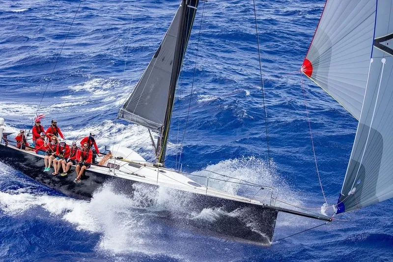 The Image of Sailboat Rogers 46 (2007) racing on open ocean with crew in red attire. - 0