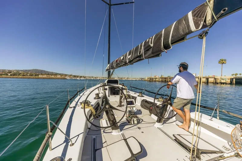 Slide: The Image of Sailboat Rogers 46, 2007 model, navigating calm waters under clear blue skies. - 11