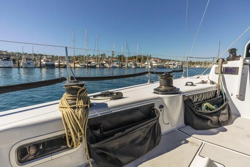 Slide: The Image of Sailboat deck view in marina, Rogers 46 model, 2007, with moored yachts in background. - 19