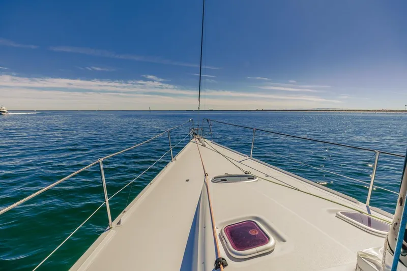 Slide: The Image of Sailing on a 2007 Rogers 46 yacht under clear blue skies. - 24