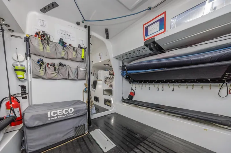 Slide: The Image of Interior of a 2007 Rogers 46 boat with organized storage and ICECO cooler. - 27