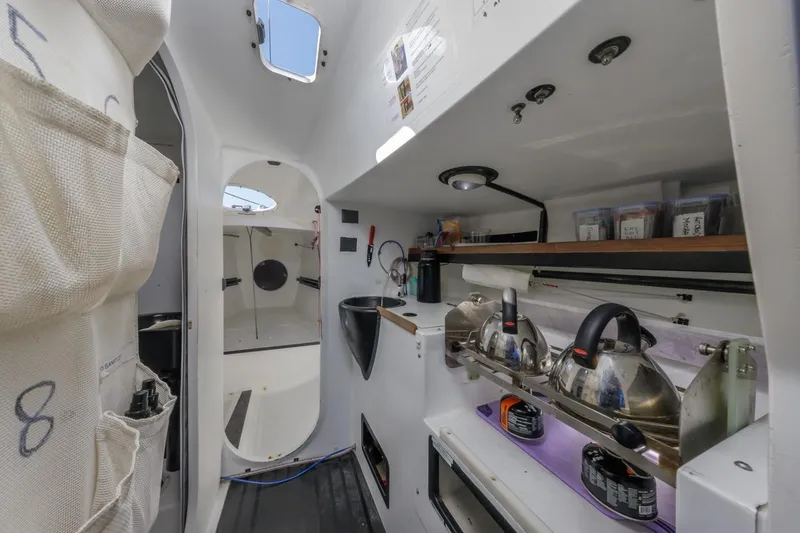 Slide: The Image of Interior of 2007 Rogers 46 sailboat with compact kitchen and storage. - 28