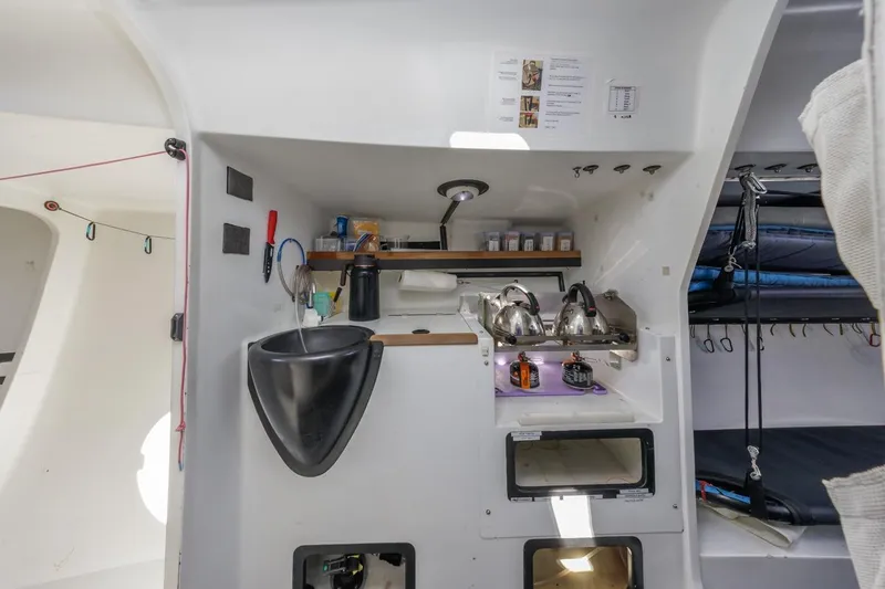 Slide: The Image of Compact kitchen area in a 2007 Rogers 46 sailboat with sink, stove, and storage. - 29