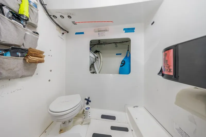 Slide: The Image of Compact marine bathroom in a 2007 Rogers 46 yacht, featuring storage and essential amenities. - 30