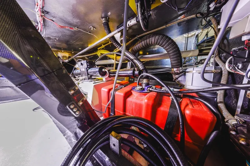 Slide: The Image of Interior view of a 2007 Rogers 46, showcasing complex wiring and red fuel tanks. - 38