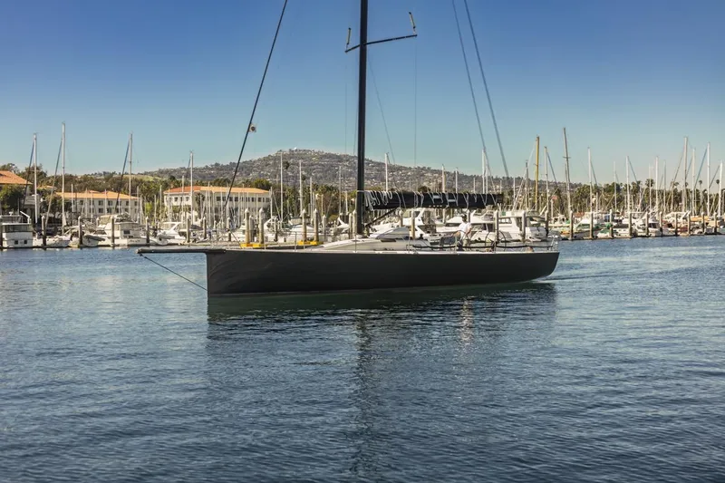 Slide: The Image of Sleek 2007 Rogers 46 sailboat docked in a marina under clear blue skies. - 4