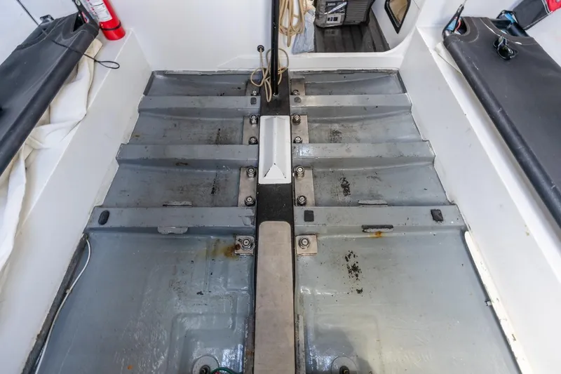 Slide: The Image of Interior view of a 2007 Rogers 46 boat, showcasing the metal flooring and equipment. - 41