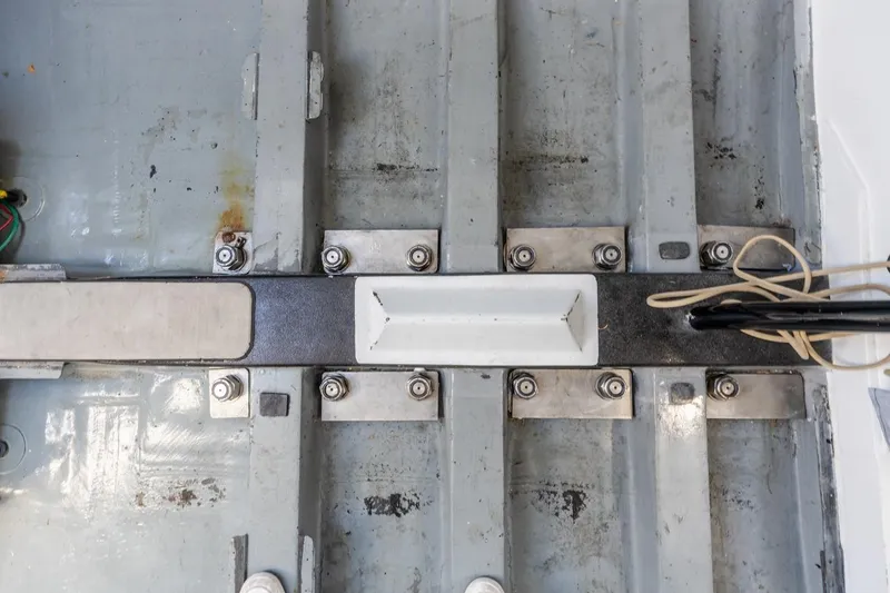 Slide: The Image of Interior view of a 2007 Rogers 46 boat showing metal framework and wiring. - 42